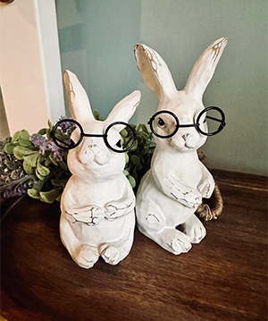photo of 2 bunny rabbit statues wearing round glasses